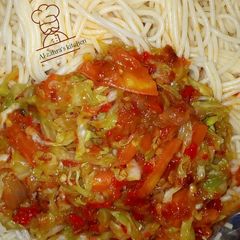 A picture of Spaghetti with cabbage and tomatoes sauce.