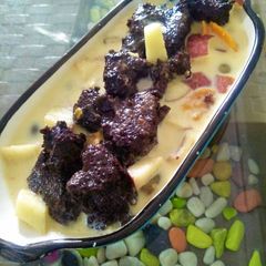 A picture of Fruit Custard and hot chocolate cake (two in one sweet)hot cake with cold fruit custard.