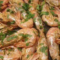 A picture of King prawns in a brandy and lemon sauce.