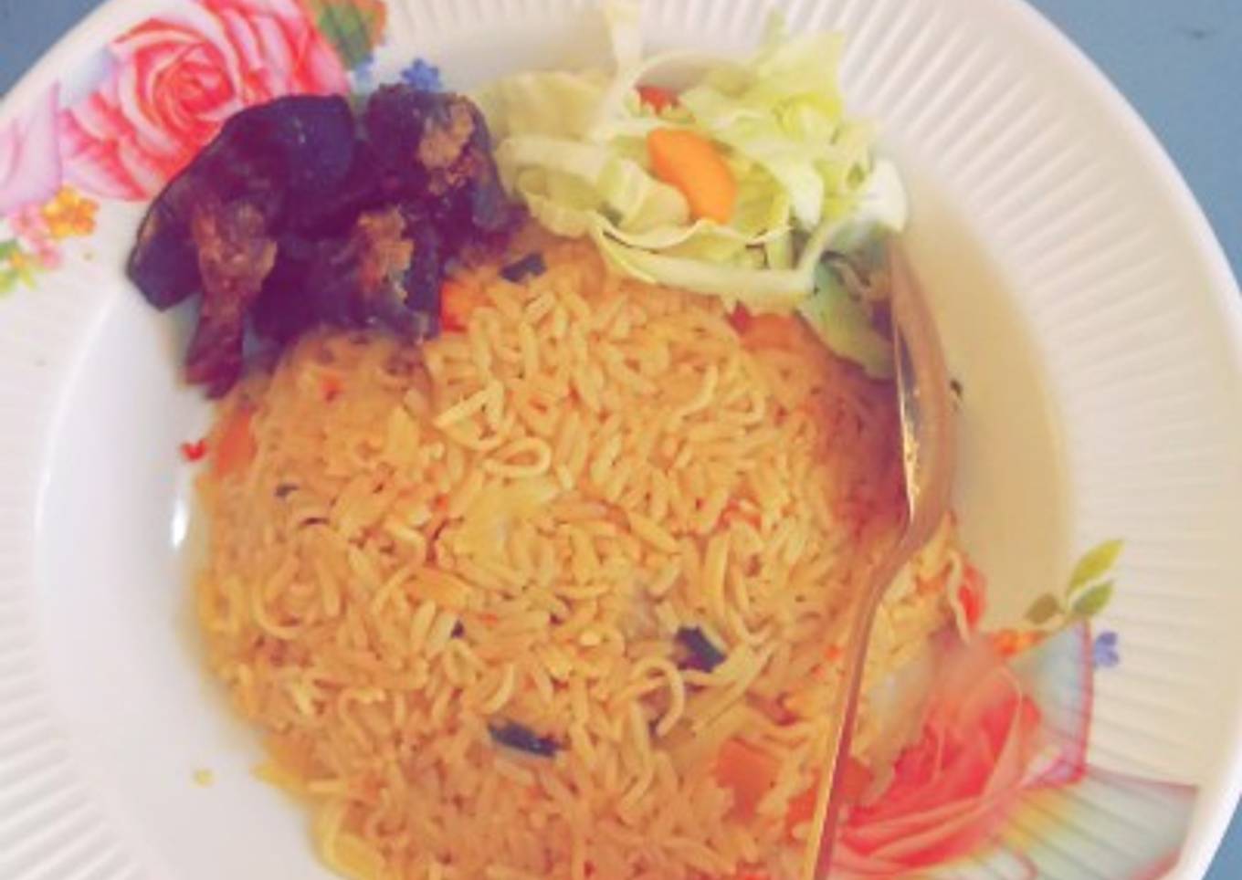 Jollof rice en spaghetti with fry meat