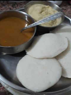 A picture of Rice Idli with coconut chutney and Sambhar.