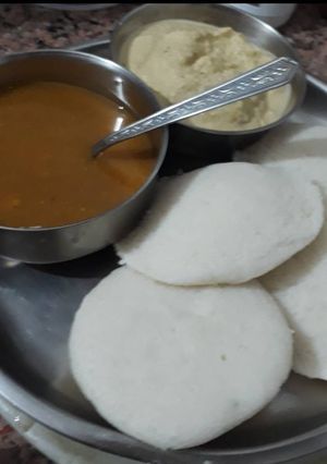 A picture of Rice Idli with coconut chutney and Sambhar.