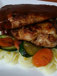 A picture of Lemon chicken, mashed potatoes and sautéed vegetables.