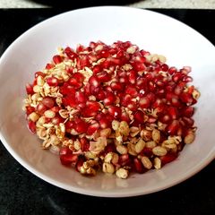 A picture of My Granola and pomegranate seeds Breakfast. 🙄.