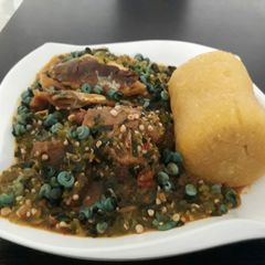 A picture of Okro soup with periwrinkle and garri.
