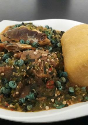 A picture of Okro soup with periwrinkle and garri.