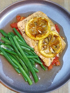 A picture of Roasted Salmon with Roasted Plum Tomatoes & Caramelized Lemons.