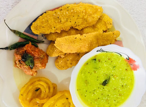 A picture of Fafda, jalebi with chutney and salad.