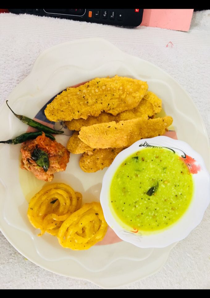 A picture of Fafda, jalebi with chutney and salad.