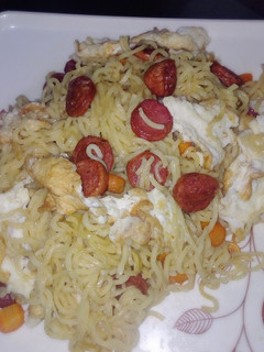 A picture of Indomie and sausage with egg.