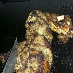 A picture of Roast leg of a lamb with mint, lemon and cumin.