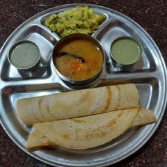 A picture of Butter Masala dosa with Potato sabji & Sambar.