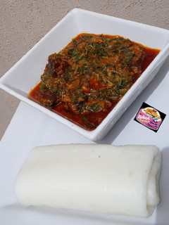 A picture of Tuwon Shinkafa (Mashed Rice) and Groundnut Soup (Miyan Gyada).