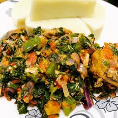 A picture of Yam n spinach sauce with smoked chicken and fish.