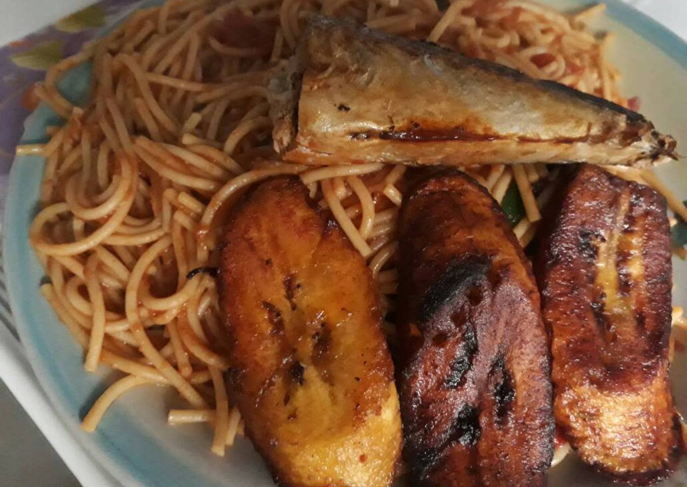 Jollof Spaghetti with fried plantain and fish