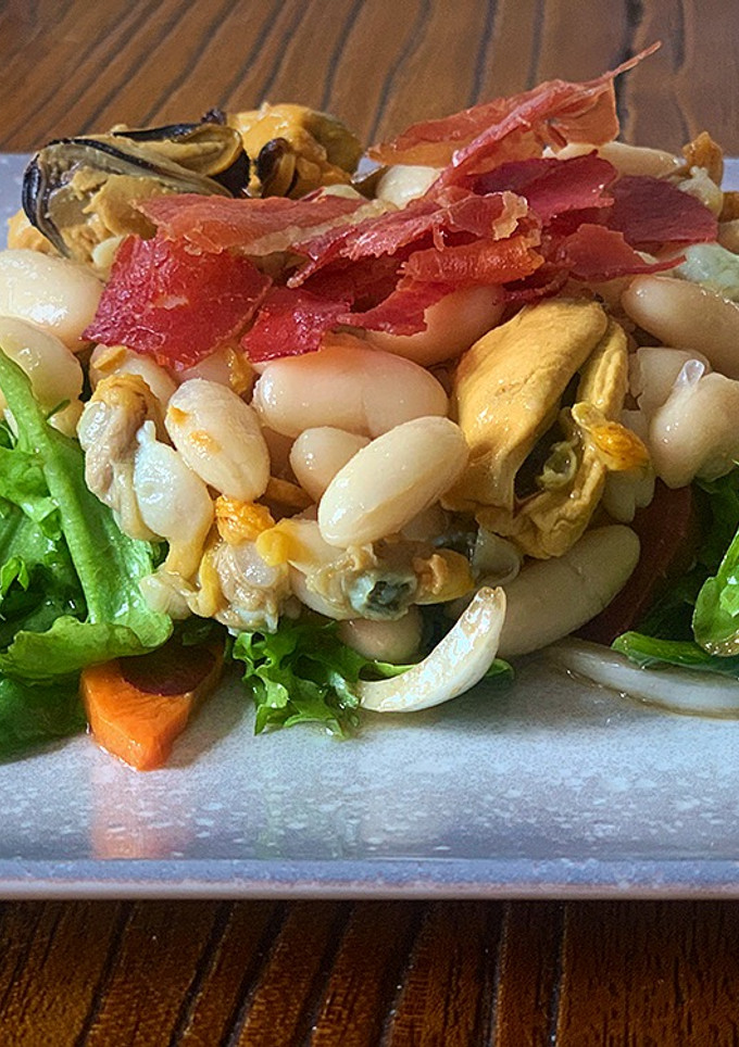 Una foto de Alubias, ensalada, marisco en lata y jamón