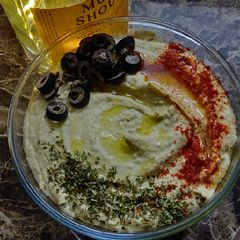 A picture of Hummus with soda cracker.