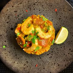 A picture of Paella, chicken, chorizo & prawns.