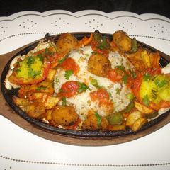 A picture of Rice sizzler with tomato coulis.