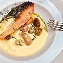 A picture of Pan seared wild Salmon with roasted potato and béarnaise sauce.