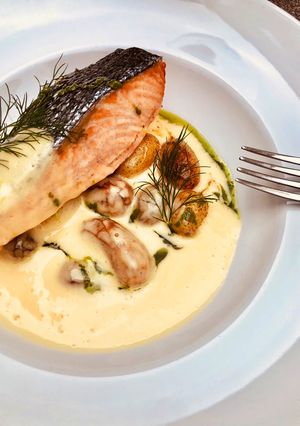 A picture of Pan seared wild Salmon with roasted potato and béarnaise sauce.
