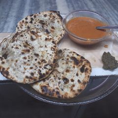 A picture of Veg keema naan with Gravy.