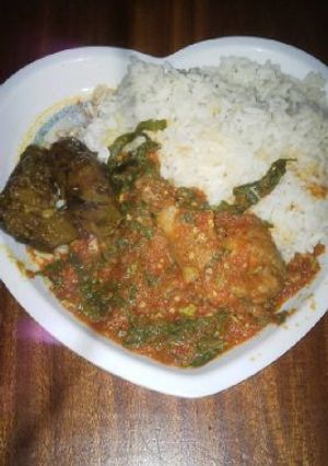 A picture of Rice with vegetable sauce.