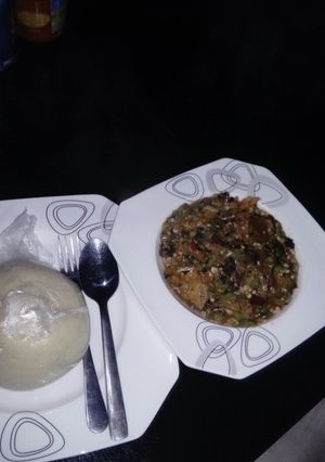 A picture of White bitter leaf okro soup with semo.