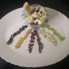 A picture of Fruit salad with ice cream.