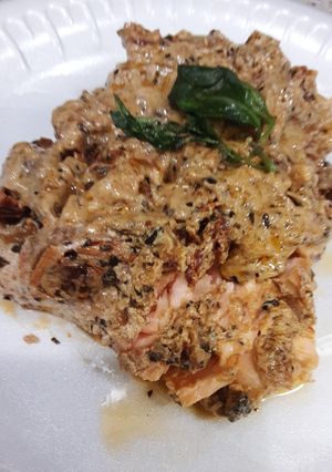 A picture of Pan fried Salmon with creamy sun-dried tomato sauce.
