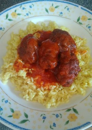 A picture of Handmade Soutzoukakia with Sauce and Rice.