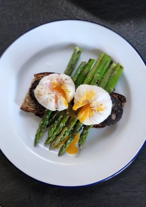 A picture of Farmers market poached duck egg, black pudding, asparagus and sourdough.