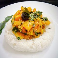 A picture of Stir fried pumpkin with spinach and coconut.