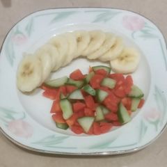 A picture of Salad, banana, carrot, cucumber, snacks time.
