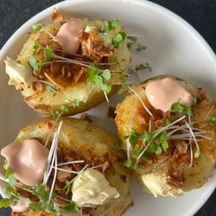 A picture of Cheddar Cheese Jack Potato, Crispy Onions & Salsa Rosa.