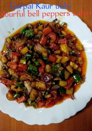 A picture of Colourful bell peppers sabzi 🍅🧅🌿🫑🌶️.