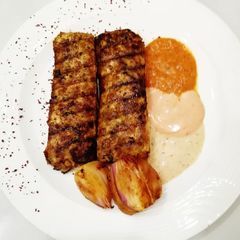 A picture of Arabian Chicken kebab along with 3 sauces.