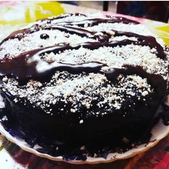 A picture of Ganache with sprinkled almonds Chocolate Cake.