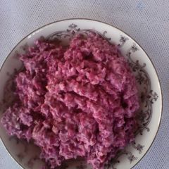 A picture of Red cabbage salad with red apple.