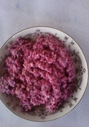 A picture of Red cabbage salad with red apple.