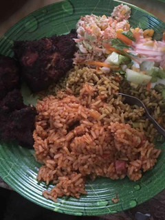 A picture of Jollof,coleslaw and grilled turkey.
