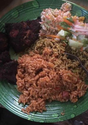 A picture of Jollof,coleslaw and grilled turkey.