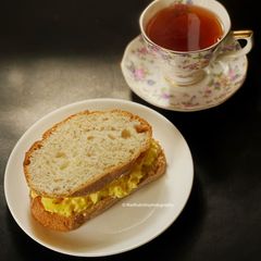 A picture of Cheesy Chilli Scrambled Egg sandwich with Darjeeling Tea.