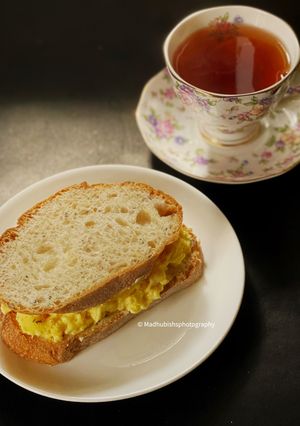 A picture of Cheesy Chilli Scrambled Egg sandwich with Darjeeling Tea.