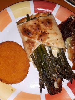Una foto de Espárragos envueltos en masa de hojaldre al horno gratinados y hamburguesa de merluza
