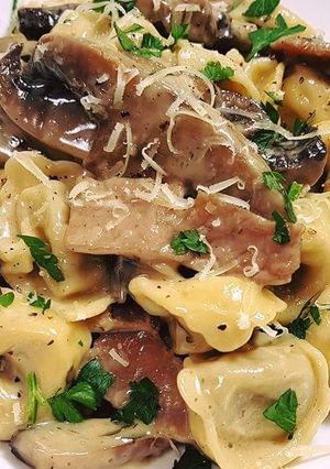 A picture of Veal tortellini with creamy mushroom, bacon sauce.