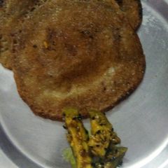 A picture of Meetha puda with mango pickle.