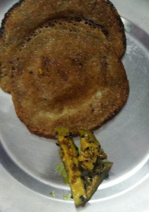 A picture of Meetha puda with mango pickle.