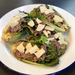 A picture of Charred baby gem with anchovy dressing 🔥🥬.