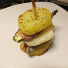 A picture of Asparagus, prosciutto and provolone potato stack.